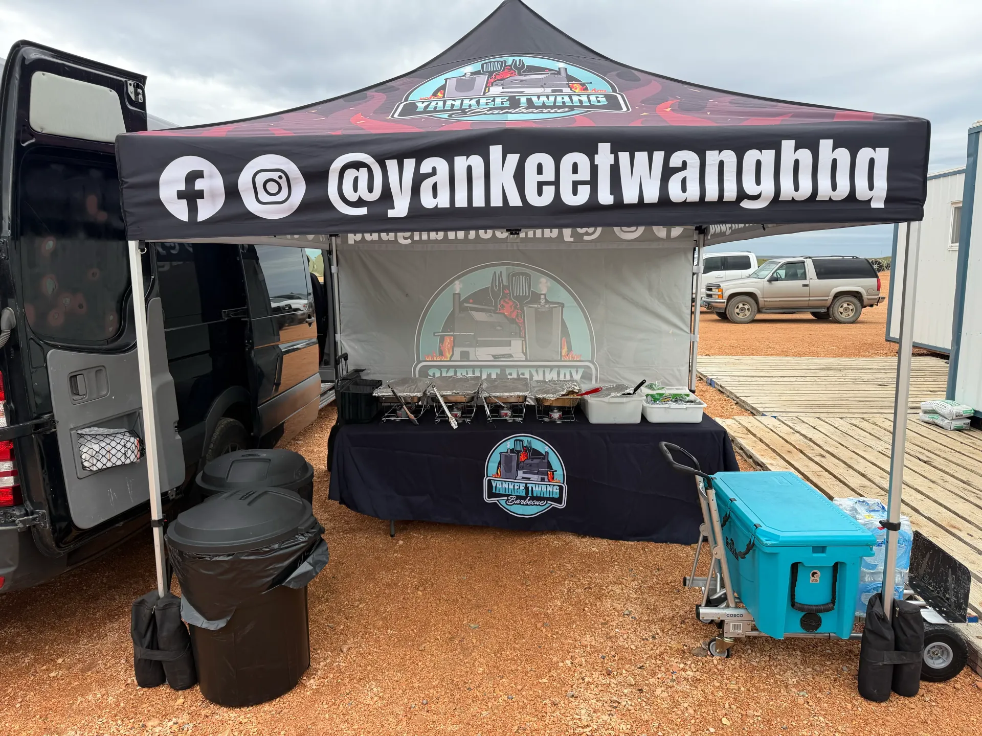 Yankee Twang branded canopy with chafing dishes, coolers, and catering gear ready for service